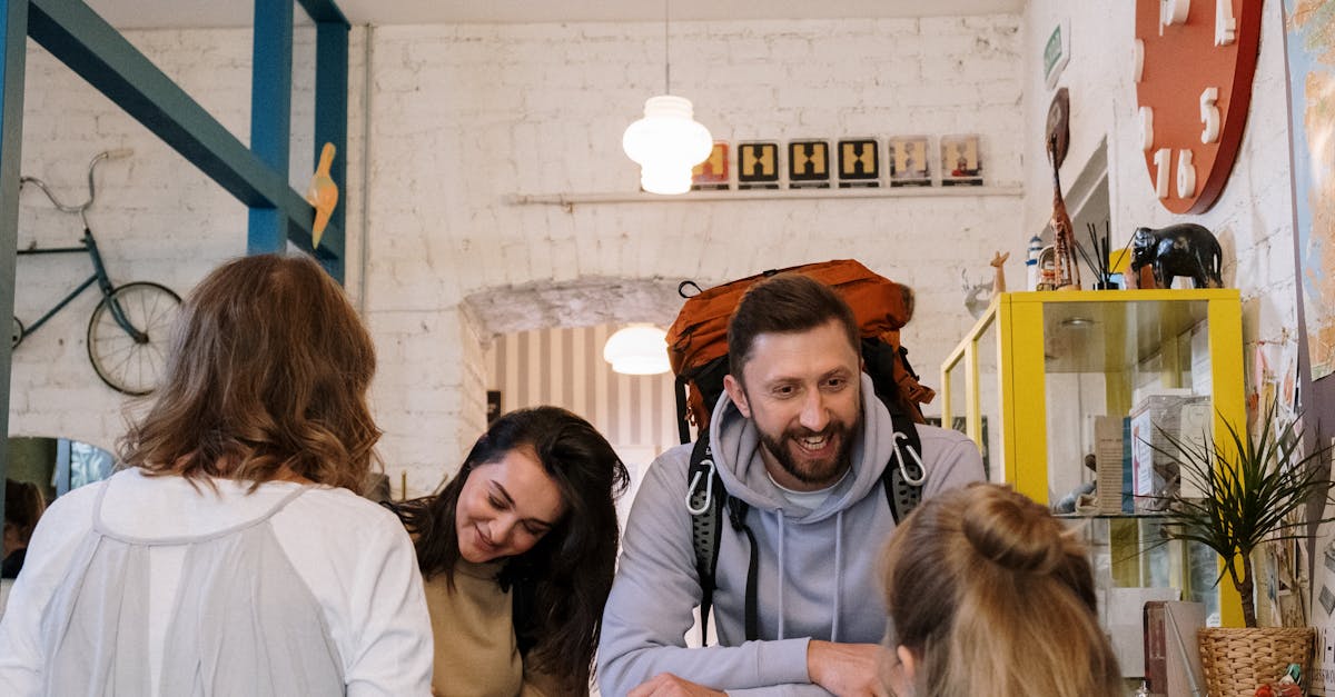 Backpackers cheerfully checking in at a vibrant hostel reception desk.