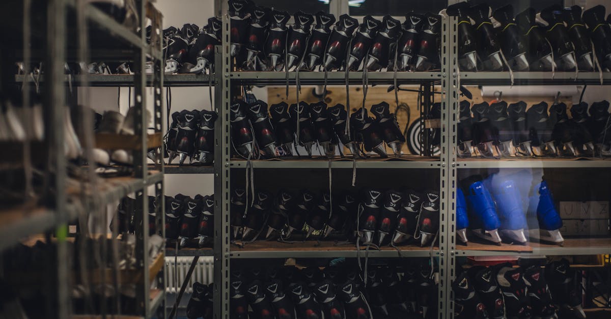 Neatly organized skate boots on shelves in an indoor shop setting, ready for sale.